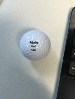 A golf ball printed with Rajesh's Golf Club